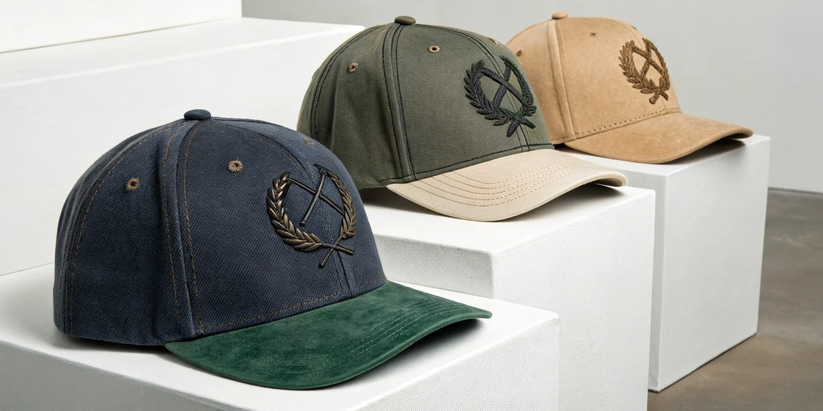 Beisbol Dandy embroidered hats in navy, olive, and tan.