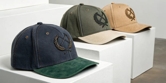 Beisbol Dandy embroidered hats in navy, olive, and tan.