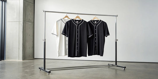 A rack of black and white Zacatecas baseball jerseys in a classic button-down style.