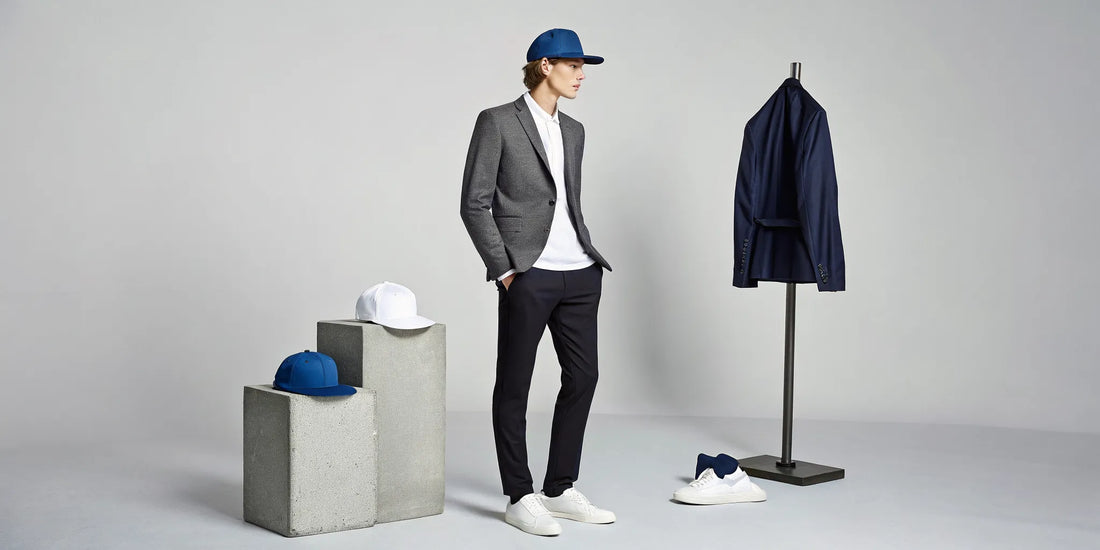 Man styling a beisbol Dodgers Dandy hat with a blazer and sneakers among a collection of Dandy hats.