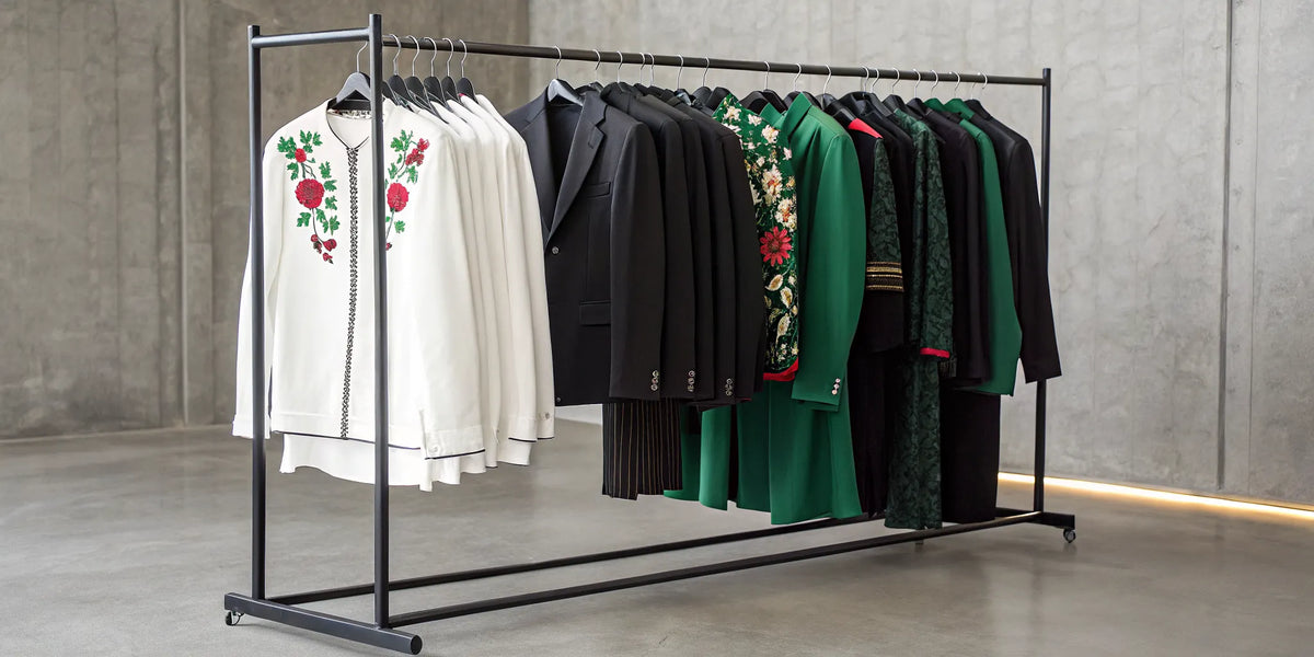 Mexican pride clothing on a rack, featuring embroidered jackets and vibrant green apparel.