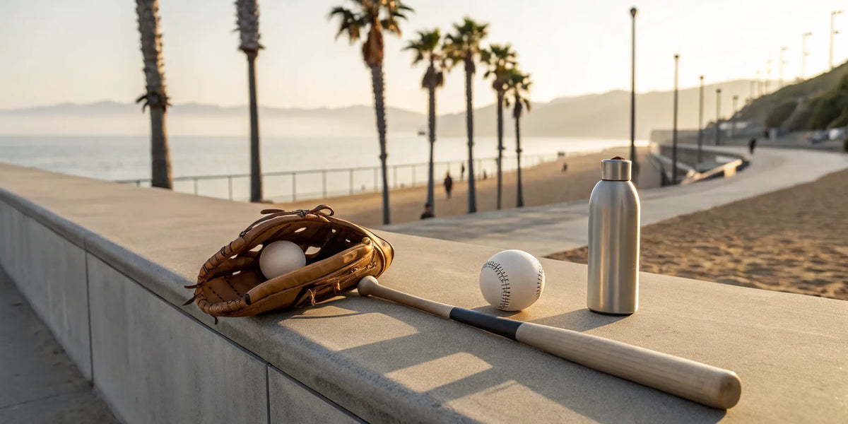 Beisbol bat and glove on a California beach, defining the local sports lifestyle.
