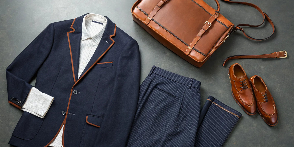 Luxury Houston beisbol apparel styled as a flat lay outfit with a blazer, pinstripe pants, and accessories.